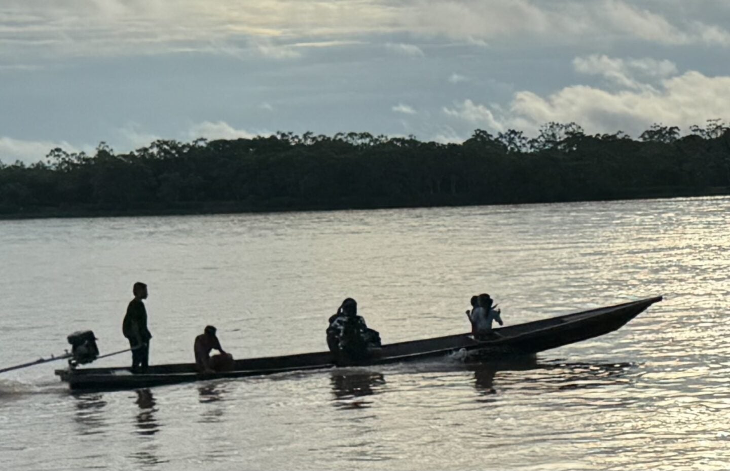 Boaters on Putamayo River, which here marks the border between Colombia and Peru (Photo Credit Masha Hamilton)