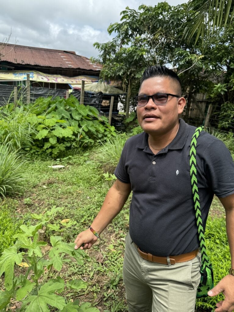 Jimmy San Juan, a Western-trained public nurse, with some. of the plants he grows to support healing. (Photo Credit Masha Hamilton)