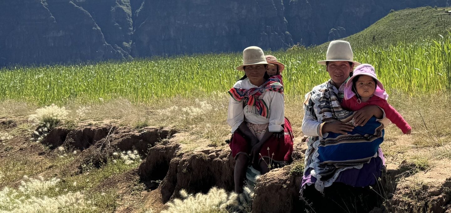 Mothers and children sit on the rocks in the hilltop community of Kewinal, Bolivia (Photo Credit Masha Hamilton)