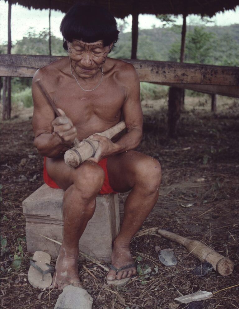 Poneh, a former member of the uncontacted Akuriyo community, carving a traditional Akihito stone axe. (Photo Courtesy of ACT)