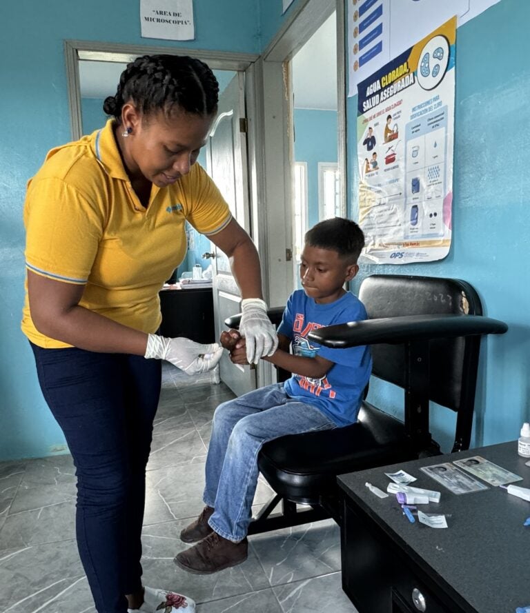 Prisma Alvarez takes a blood sample to check for malaria on Mocoron, Honduras (Photo Credit Masha Hamilton)