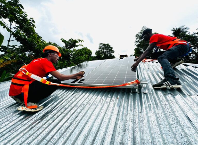 Installing solar panels on a customer's roof in Plaisance, Haiti, July 2024 (Photo Courtesy of Alina Enèji)