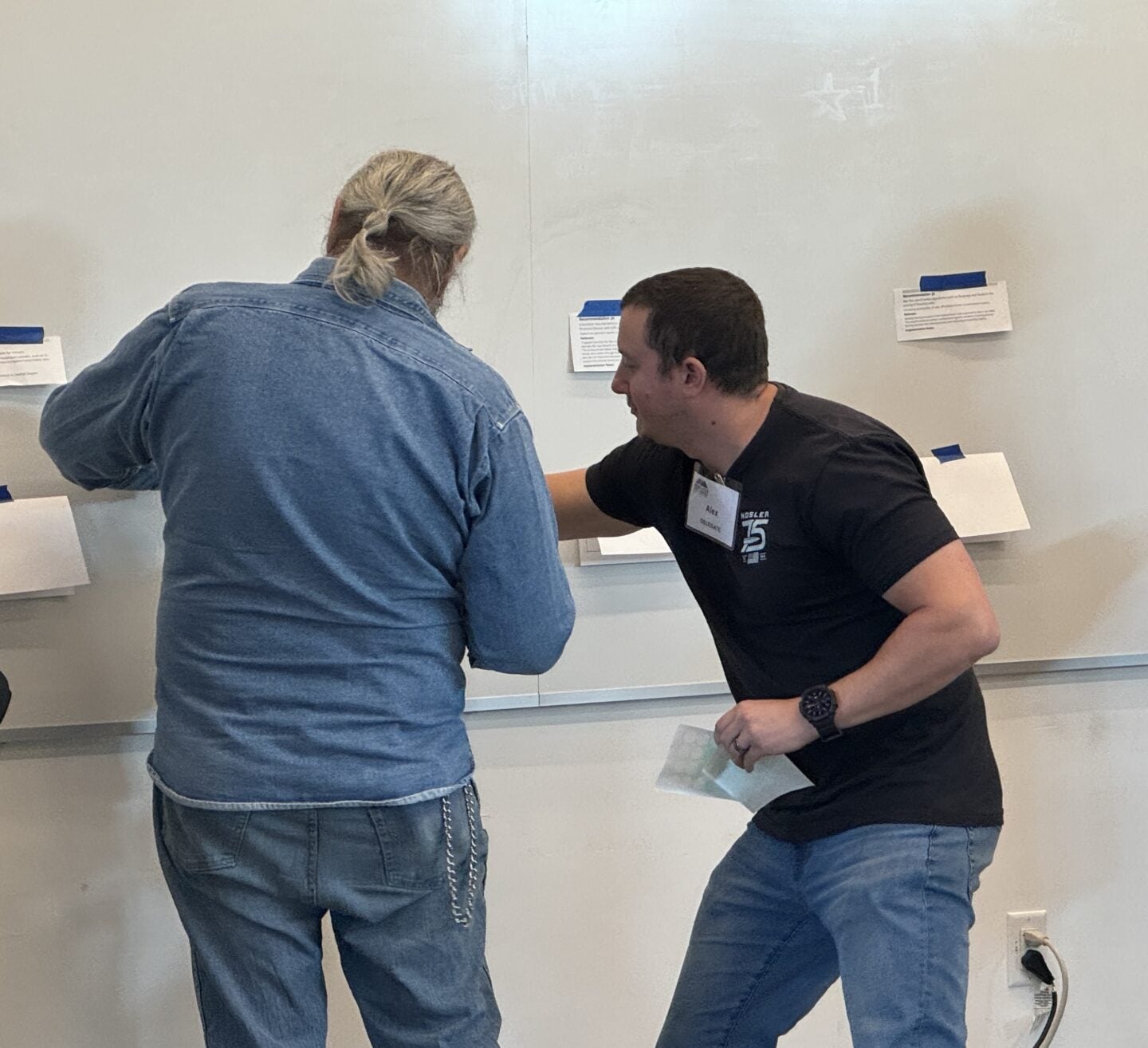 Two delegates make their final votes on a honed down list of 33 proposal for how to fight the county's youth homelessness (Photo Credit Masha Hamilton)