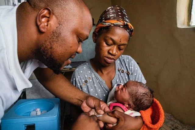 Riders for Health worker treating a small child.