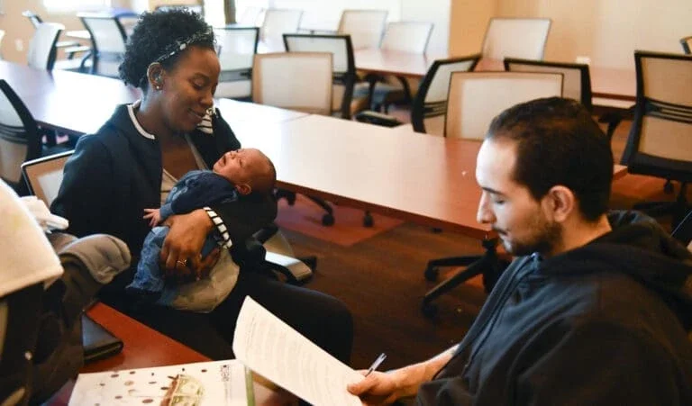 A woman and baby receive family EITC tax benefits.