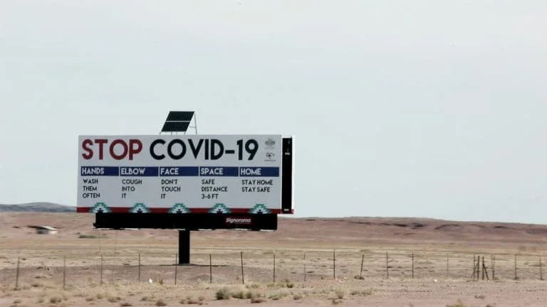 Billboard sign detailing ways to prevent the spread of Covid-19.