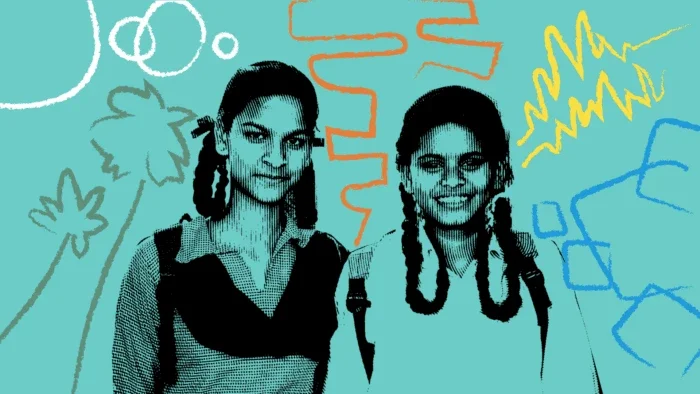 two women standing with backpacks on smiling.