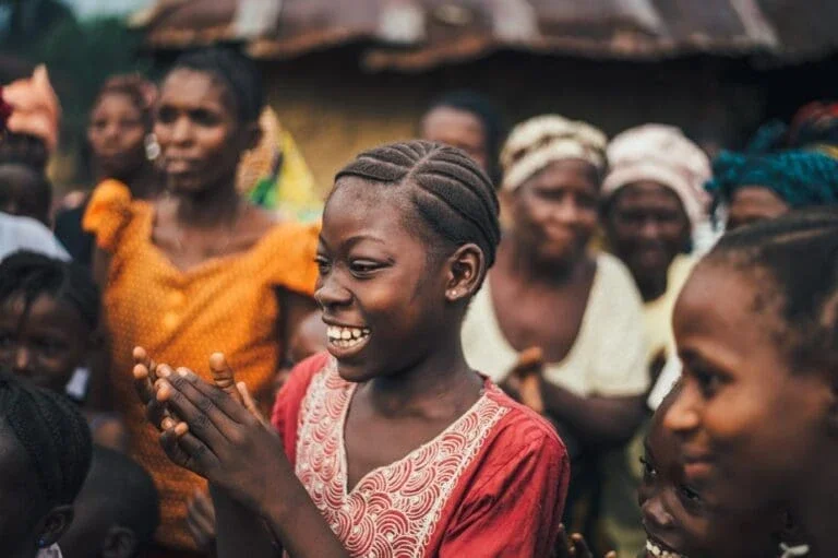 young girl clapping and smiling.