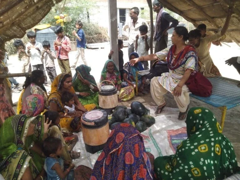 women sitting with their children.