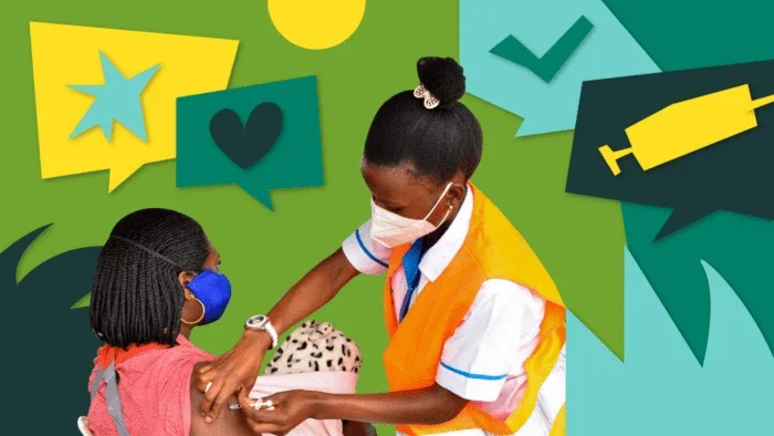 woman health care worker giving a woman the vaccine shot.