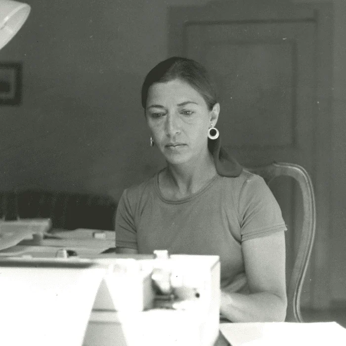 woman sitting in a chair at a table working.