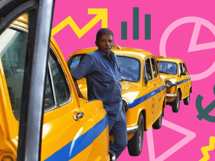 man standing next to taxi's