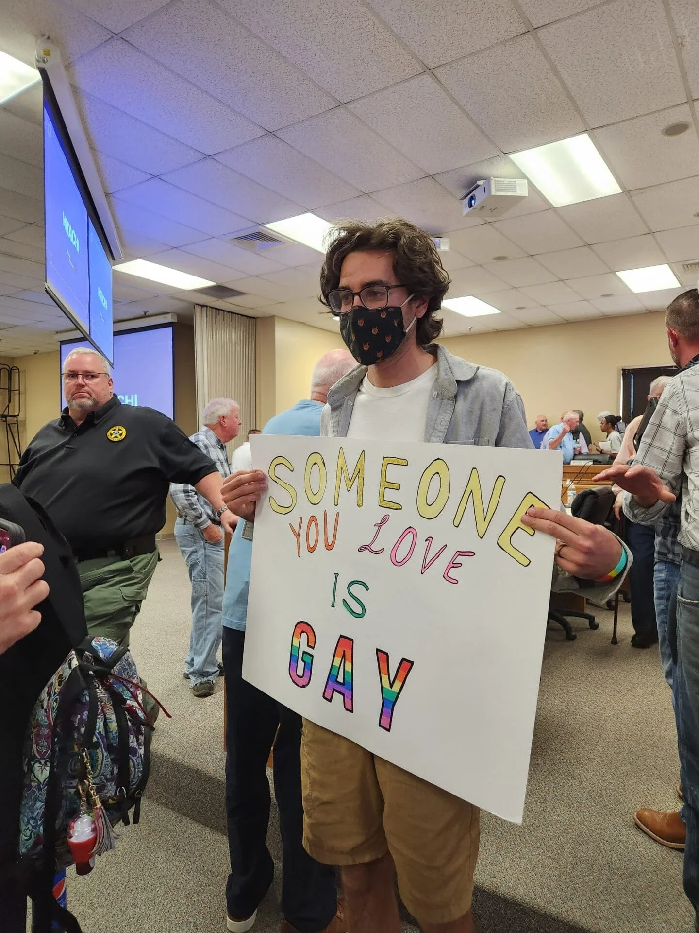 Pride Activist in Tennessee holds sign