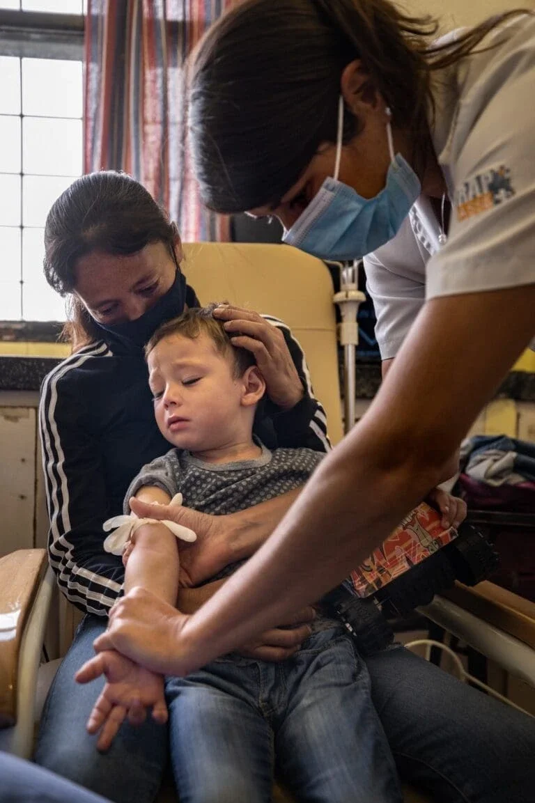 Drawing blood from a boy in Uruguay to check for lead levels