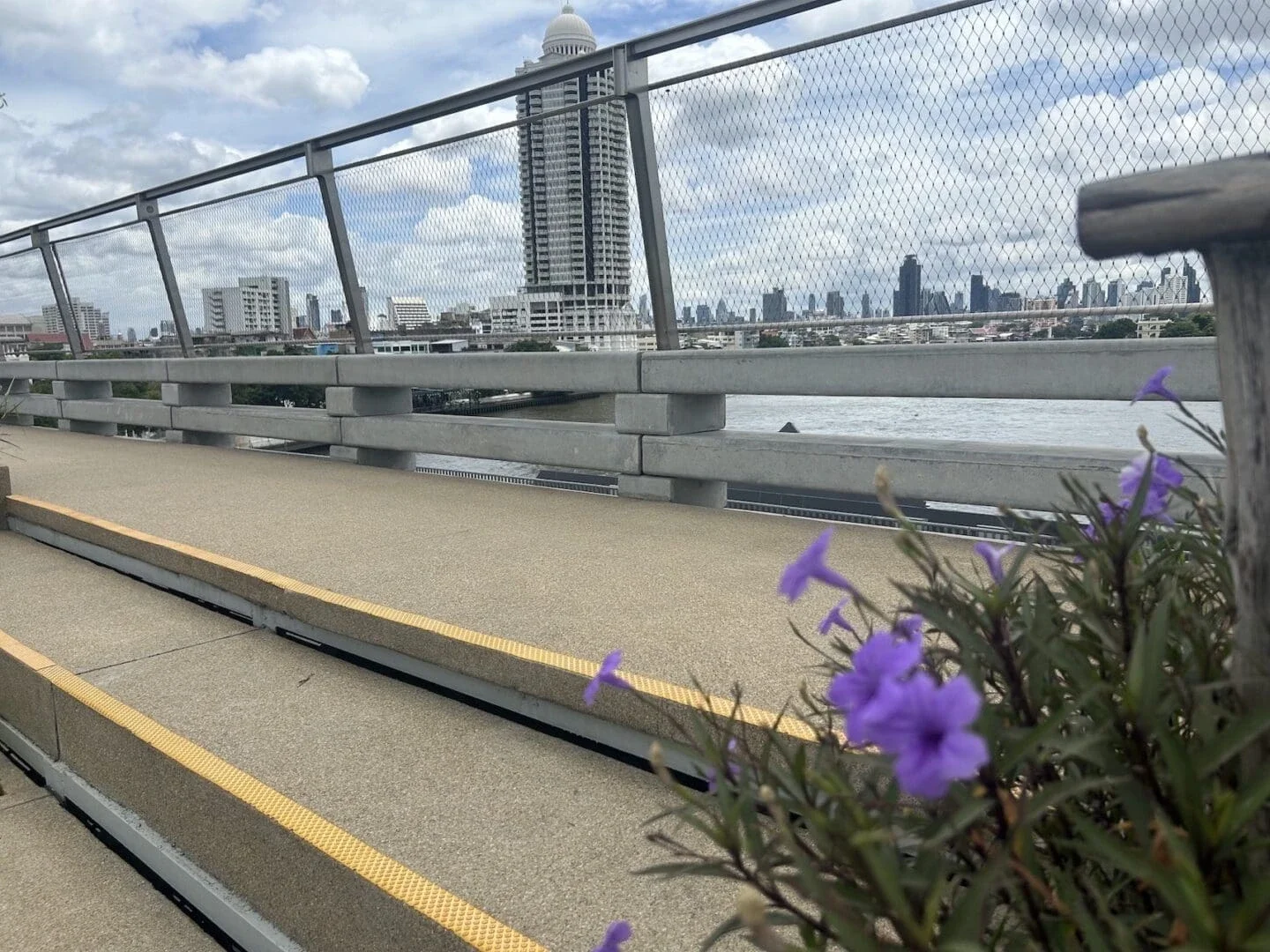 view of water and sky scraper building from a bridge