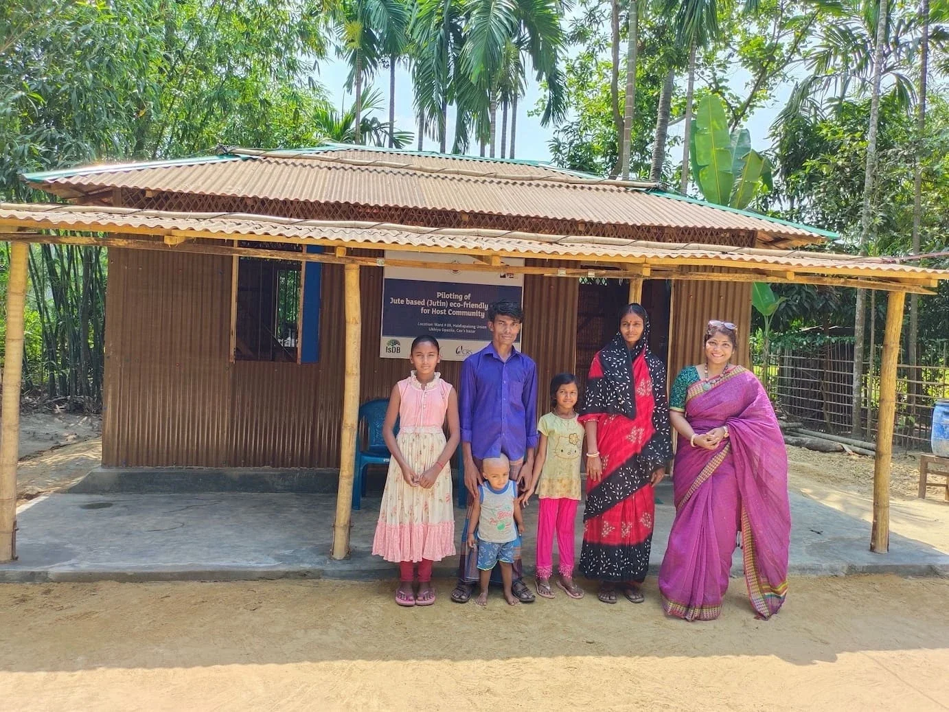 Dr. Jahan in front of jute based housing (Photo Courtesy of Dr. Jahan)