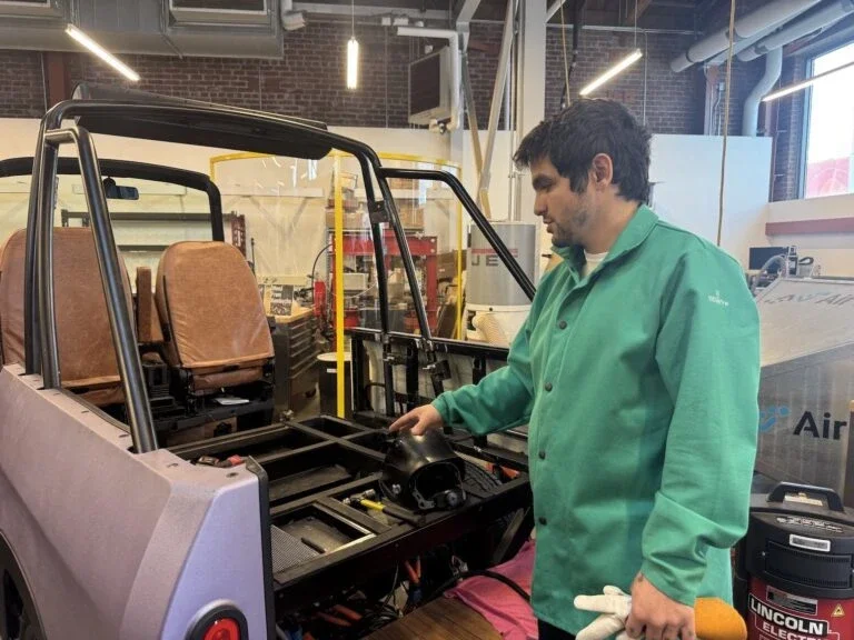 A technician working on an entrepreneur's prototype for an electric vehicle in LACI's Advanced Prototyping Center (Photo Credit Masha Hamilton)