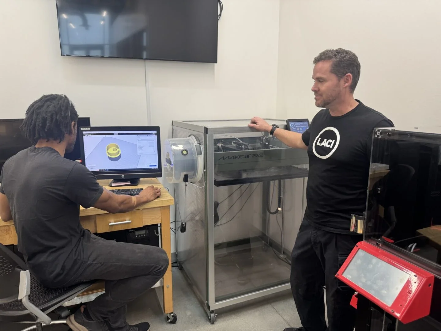 Nick Albert (right) senior manager of LACI's Advanced Prototyping Center, next to the 3-D printer (Photo Credit Masha Hamilton)