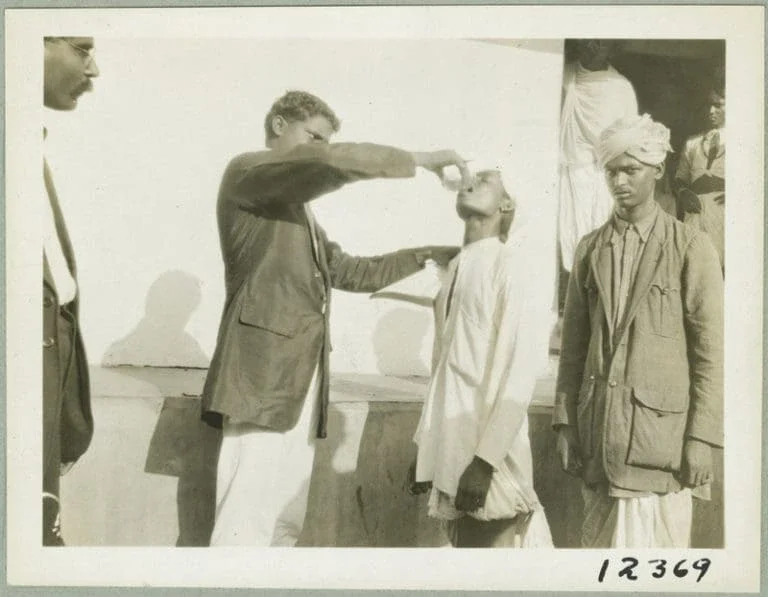 Doctor administering hookworm treatment at Karapa, India.