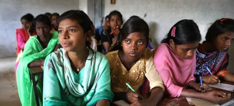 Room of adolescent girls learning about sexual and reproductive health in India.