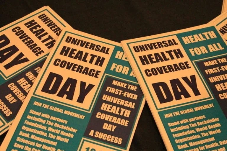 Universal Health Coverage pamphlets laying on a table.